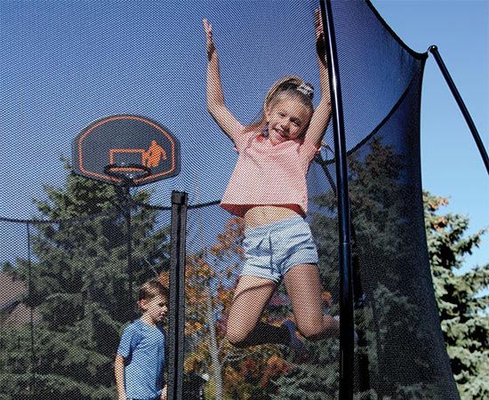 two kids playing on trampoline